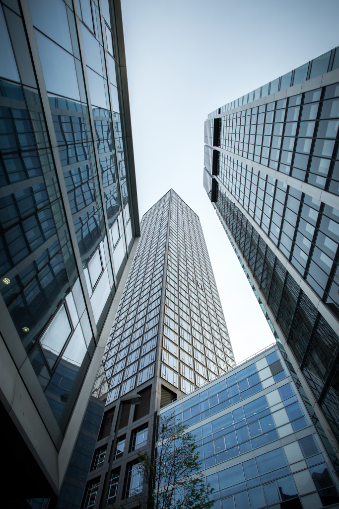 vertical-low-angle-shot-high-rise-skyscrapers-glass-facade-frankfurt-germany 1.png
